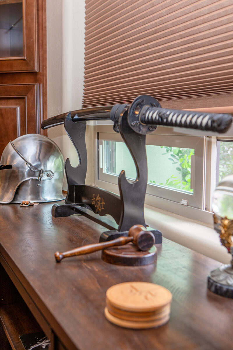 Shelf display — katana on stand, sallet helmet, and gavel