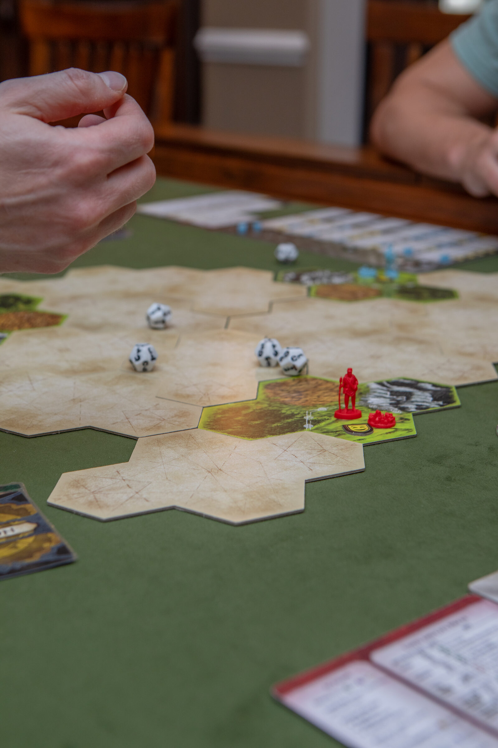 Clash of Cultures �� dice roll with red miniature on hex terrain