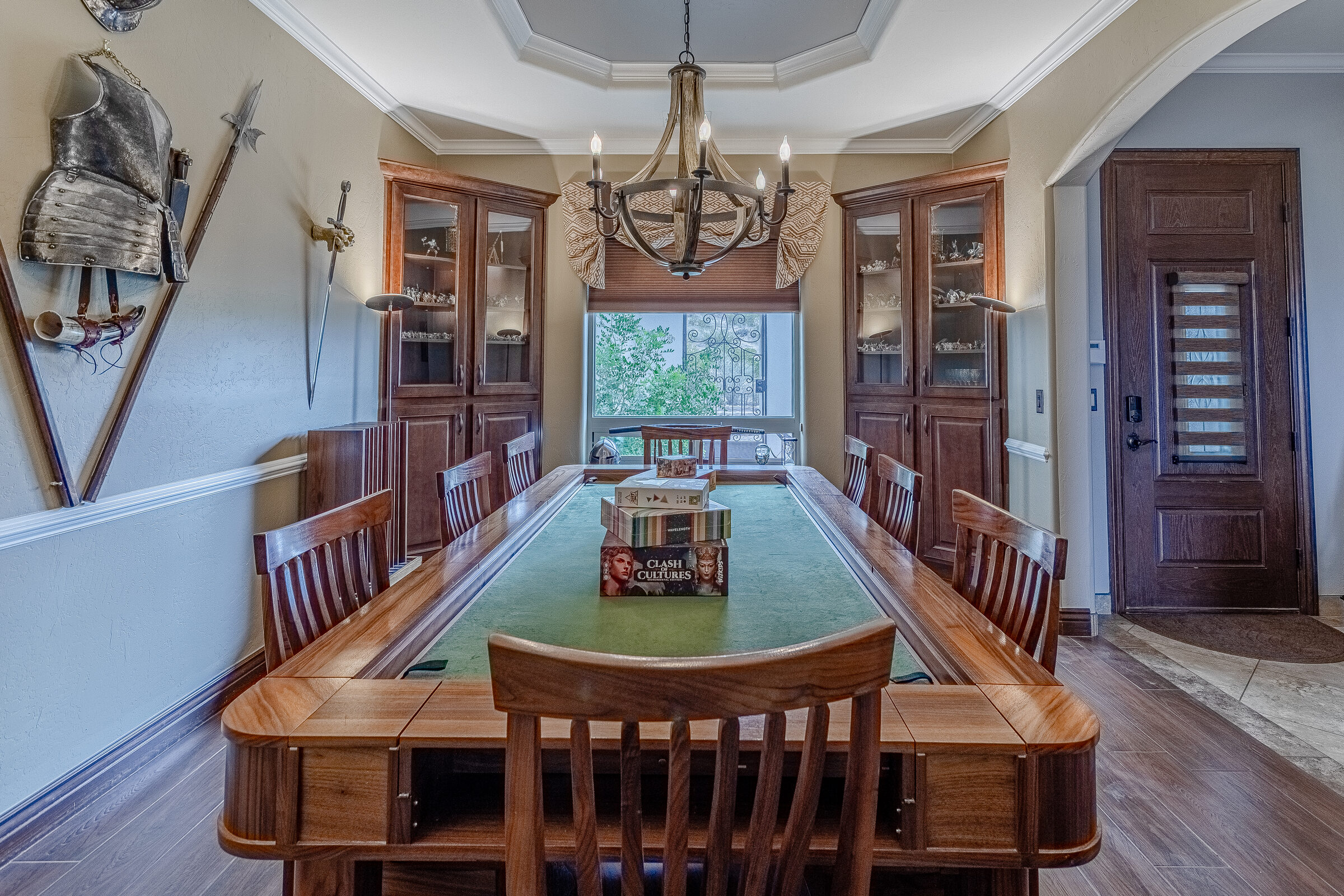 Game room — shelves of board games, map tapestry, armor display