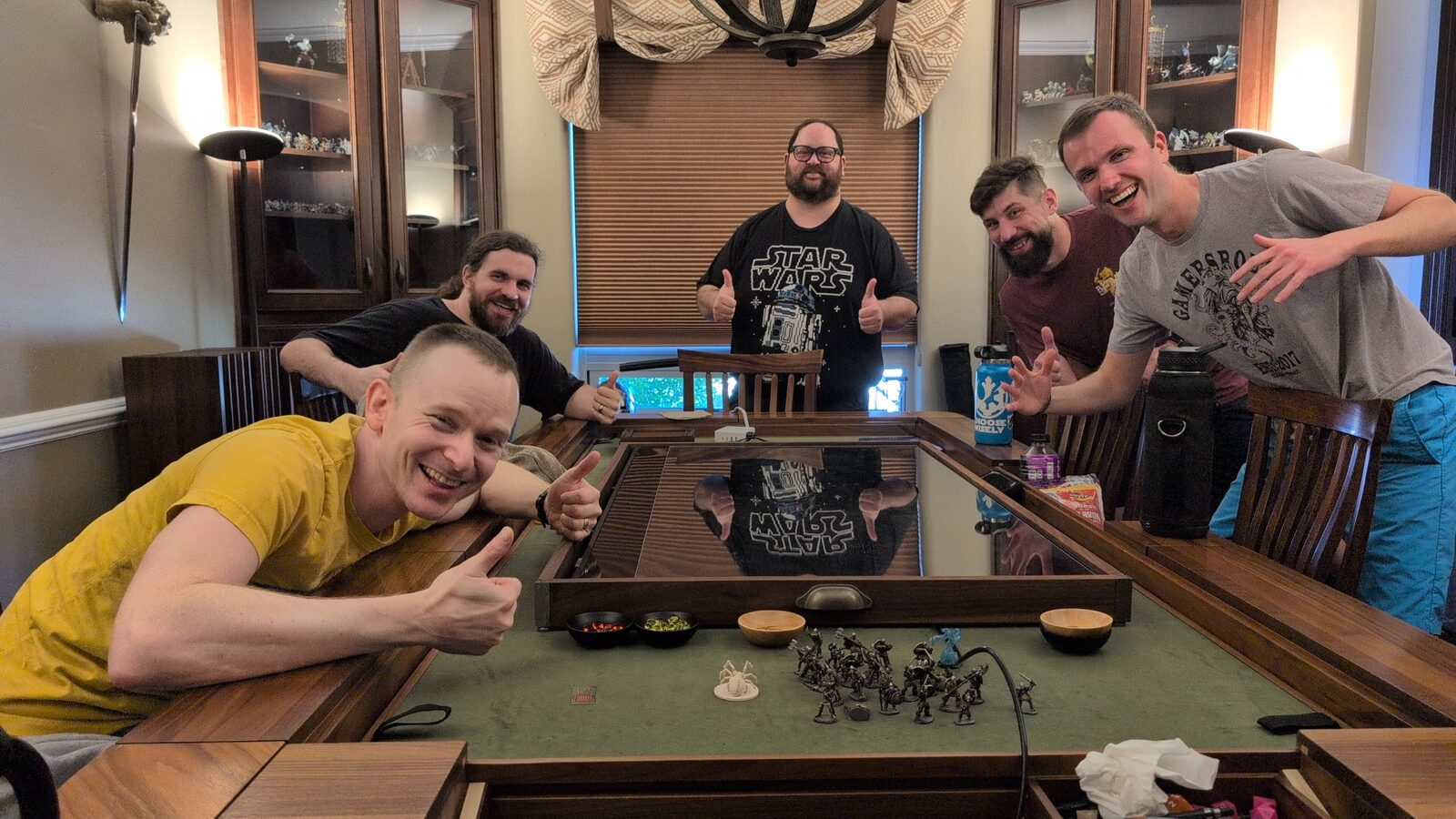 Sunday TTRPG group — five players with painted miniatures around the gaming table